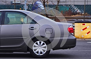 Child`s Hand Slapping Car Window