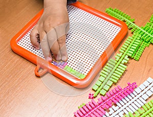 Child's hands assembling puzzle