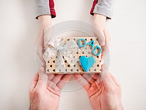 Child`s hands and a beautiful gift box