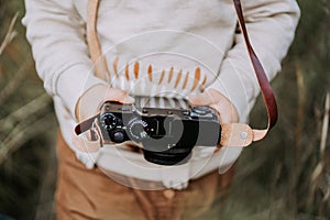 Child`s hands close-up with vintage retro camera. Boy studying to take pictures.