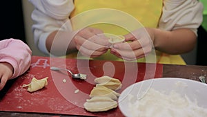 child's hands cooking ravioli, dumplings, dumplings from dough and minced meat. children's hands prepare ravioli