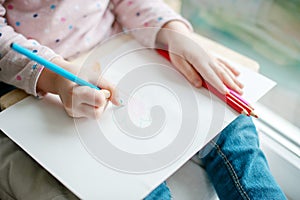 Child`s hands, paper and pencils