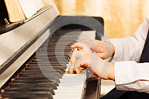 Child's hands playing on the piano-keys
