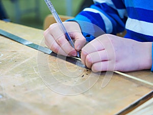 child's hands on the ruler mark size of the product