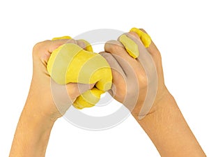 The child`s hands squeeze the yellow lime isolated on a white background.