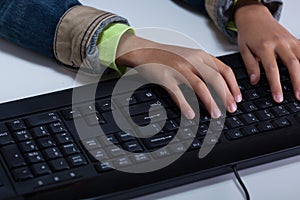 Child's hands typing on keyboard