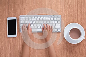 Child& x27;s hands typing on keyboard