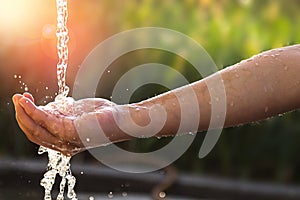 Child's Hands Under Water Tap