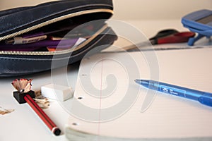 Child`s homeschooling desk with pencil case, pen, calculator and paper