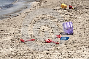 A child`s losted plastic sand buckets raker and scoop at the beach. Sunny day on Mediterranean sea