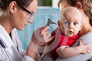 Child's otolaryngologist doing ear examination