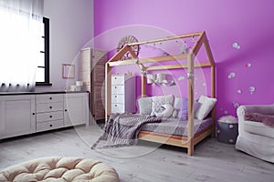 Child`s room interior with comfortable bed