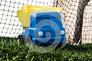 A child`s toy truck. The truck is in the grass. Old toy truck