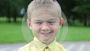 Child is sad boy, then becomes cheerful and laughs, close-up