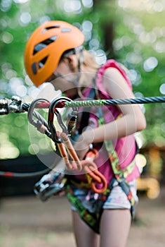 Child with safety carabiner at canopy walkway