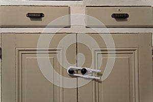 A child safety lock on cabinet doors