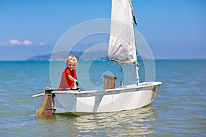 Child sailing. Kid learning to sail on sea yacht