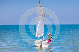 Child sailing. Kid learning to sail on sea yacht