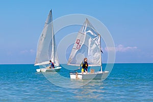 Child sailing. Kid learning to sail on sea yacht