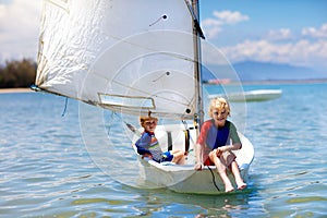 Child sailing. Kid learning to sail on sea yacht