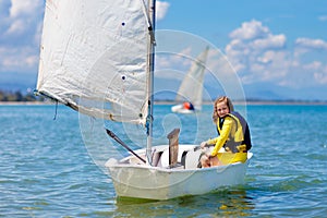 Child sailing. Kid learning to sail on sea yacht