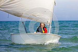 Child sailing. Kid learning to sail on sea yacht