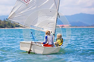 Child sailing. Kid learning to sail on sea yacht