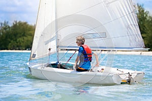 Child sailing. Kid learning to sail on sea yacht