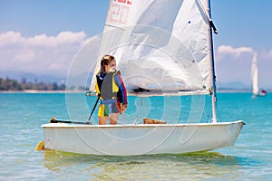 Child sailing. Kid learning to sail on sea yacht