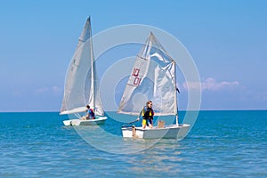 Child sailing. Kid learning to sail on sea yacht photo
