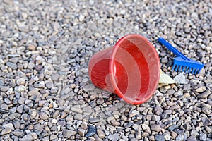 Child sand toys over stony playground