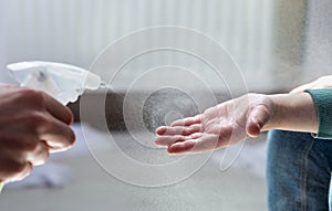 Child sanitizing hands to make it clean