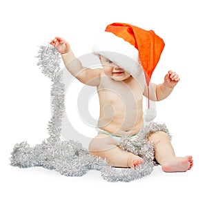 Child in Santa Claus red hat and tinsel