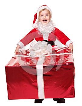 Child in santa costume giving gift box.