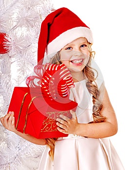 Child in Santa hat with gift box.