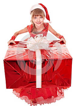 Child in santa hat giving red gift box.