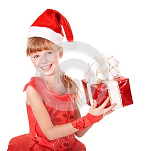 Child in santa hat holding red gift box.