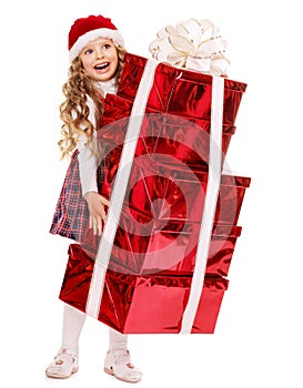 Child in Santa hat with stack gift box.