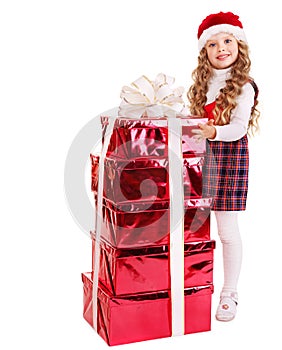 Child in Santa hat with stack gift box.