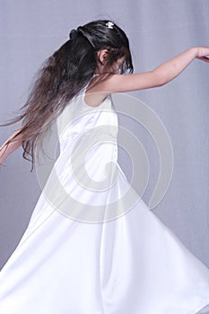 Child in satin dress twirling