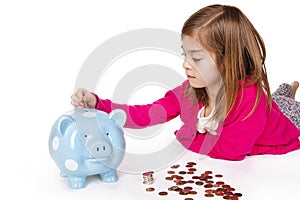 Child Saving money in a piggybank photo