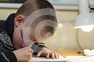 Child school age boy making his homework