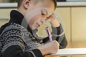 Child school age boy making his homework