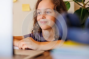 child at school. the child uses a laptop for learning. training using modern technologies