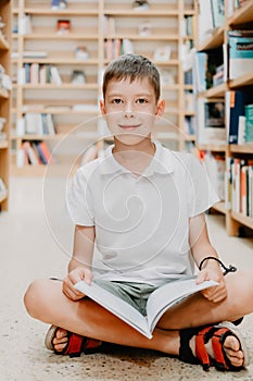 Child in school library. Kids read books. Little boy reading and studying. Children at book store. Smart intelligent preschool kid