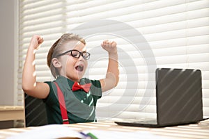 Child schoolboy pupil learn english online at school. Education for smart kids. Excited school boy in class.