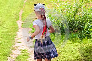 Child schooler with smartwatch running outdoor park. Kid using smartwatches active lifestyle sport. Schoolgirl walking