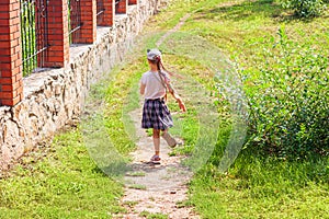 Child schooler with smartwatch running outdoor park. Kid using smartwatches active lifestyle sport. Schoolgirl walking