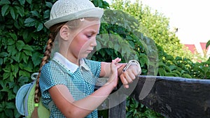 Child schooler using smartwatch outdoor park. Kid talking on vdeo call with parents on smartwatches. Smart wristwatch GPS tracker