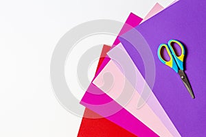 Child scissors with colorful paper on white background